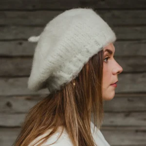 Woman in side profile wearing a white knitted beret