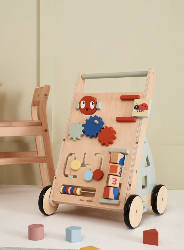 Kid's concept Baby Walker displayed in a beige room